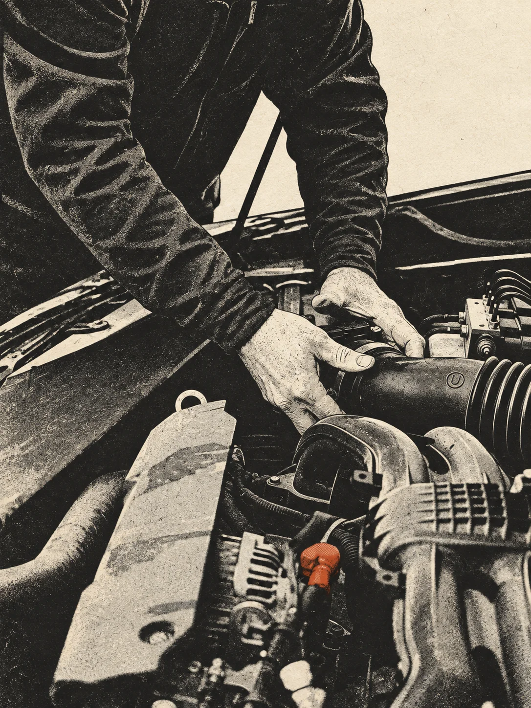 Hände eines Mechanikers bei der Arbeit im Motorraum.